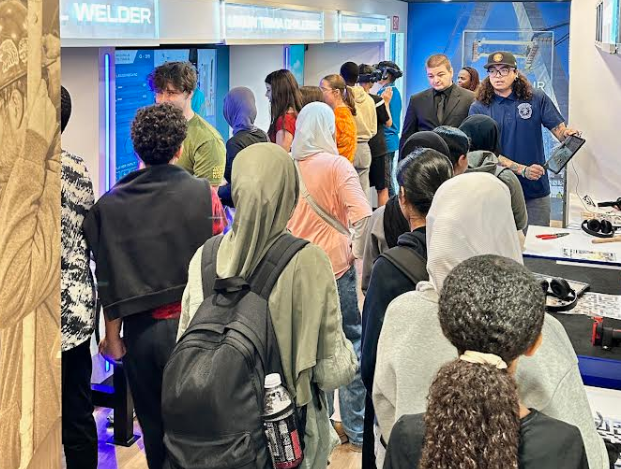 Students gather inside the Schools for Tools trailer to engage in the event activities.