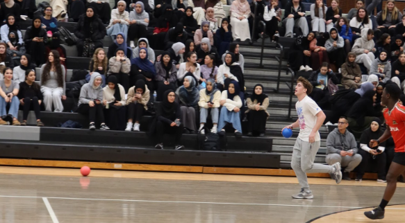 The tenth grade team approaches the center of the gym during the dodgeball event. 